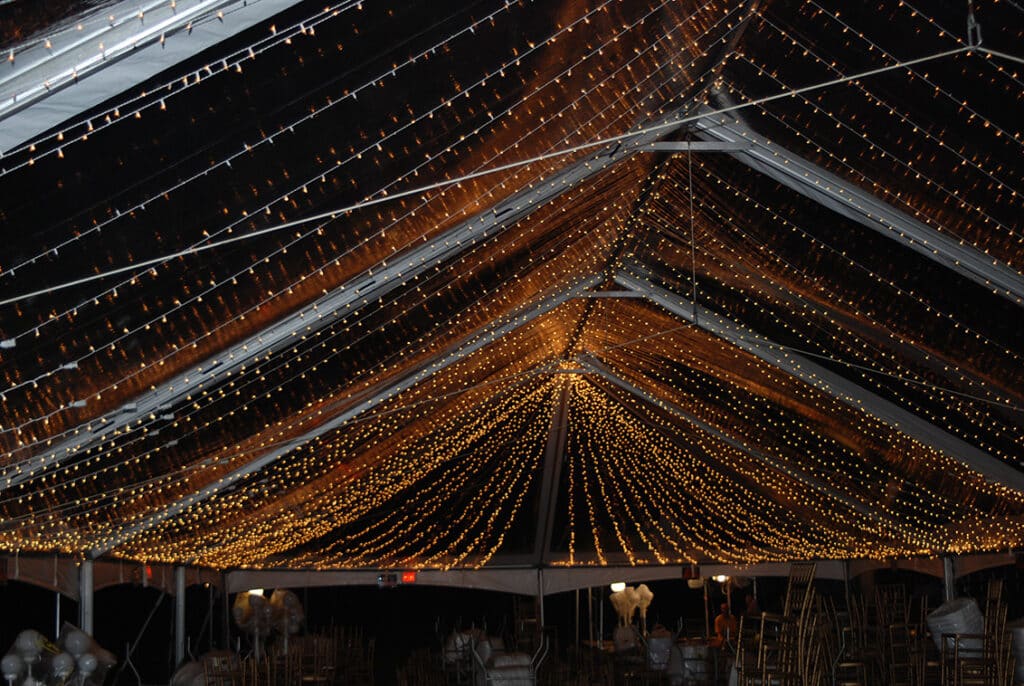 Dramatic tent ceiling lighting for an evening event
