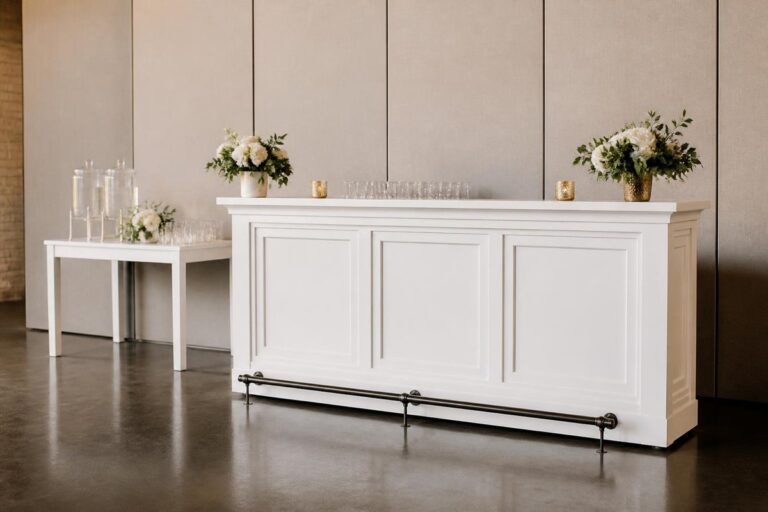 Portable white reception bar beside a separate water station