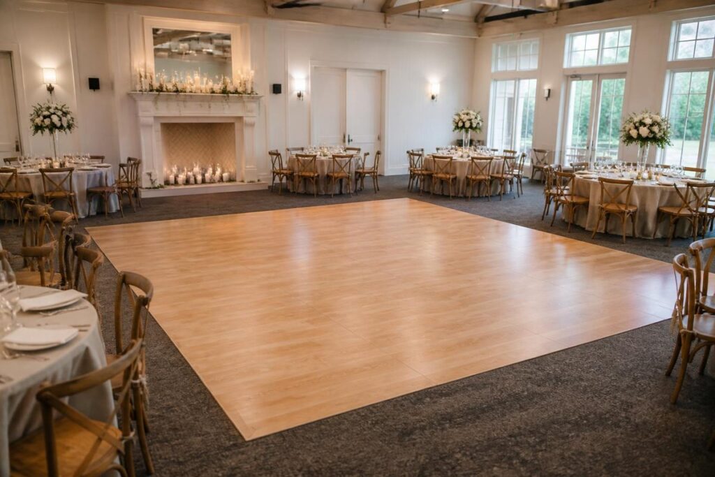 Wood dance floor surrounded by reception dinner tables