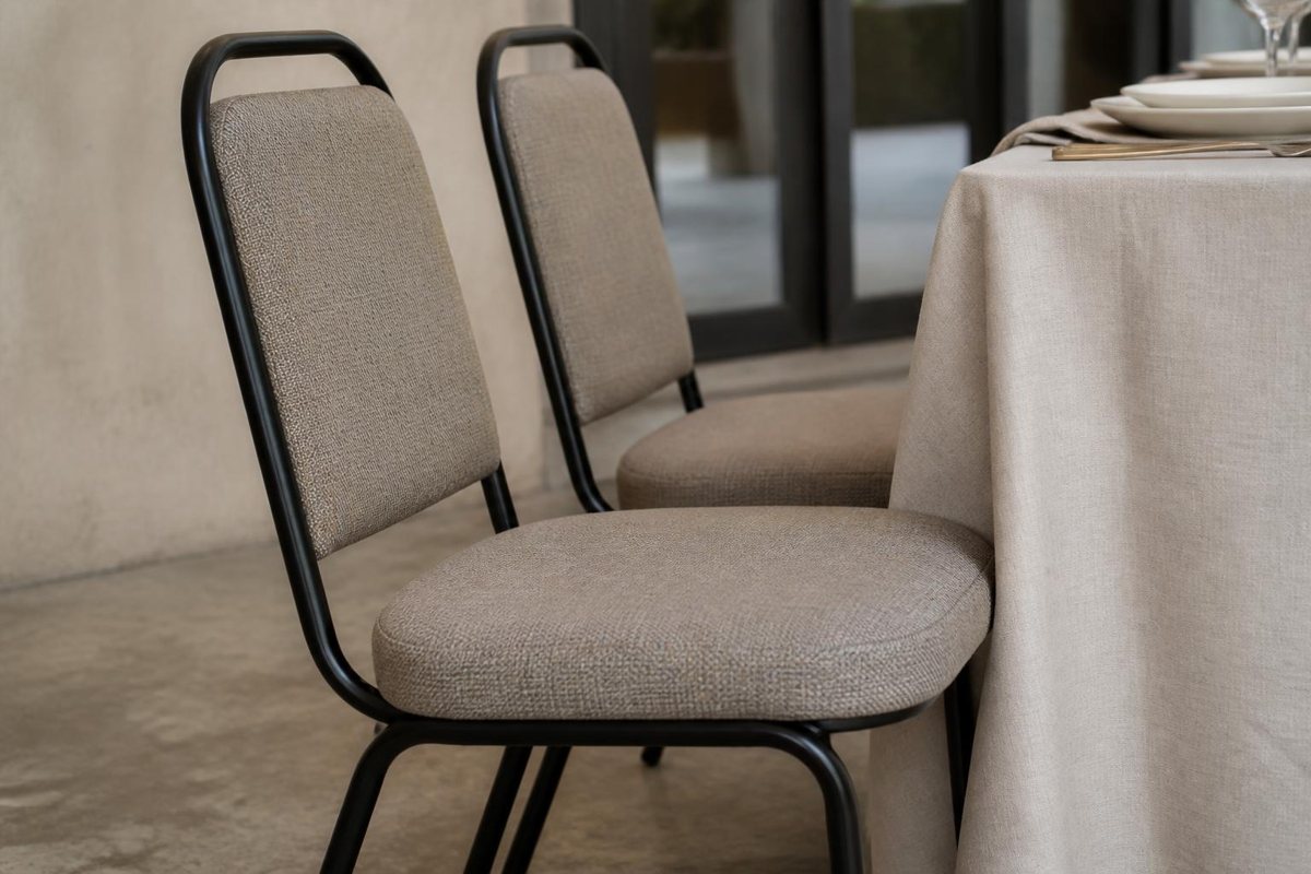Two padded event chairs beside a linen-covered dining table