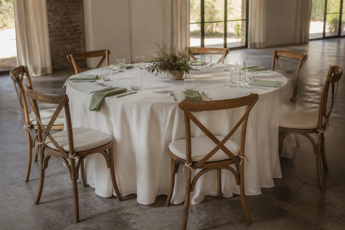 Round reception table with six chairs and low greenery