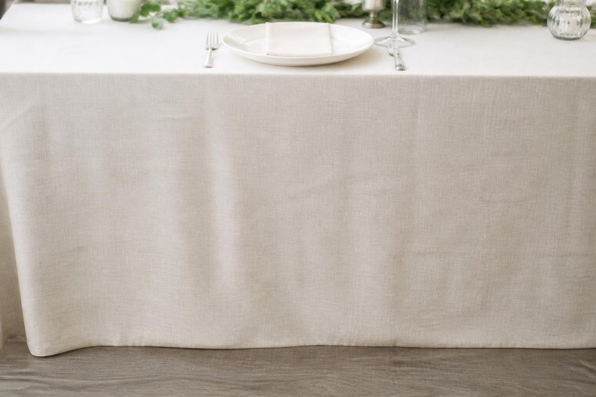 Ivory tablecloth hanging evenly along a rectangular table