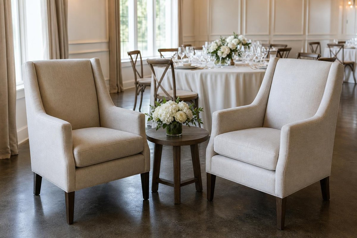 Two upright upholstered armchairs and a side table in a reception lounge