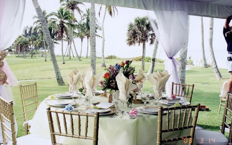 Wedding table and ceremony setup under a white tent in Southwest Florida